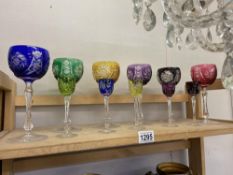 A set of 6 coloured crystal glasses and a set of 5 small ones