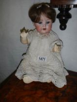 An Armand Marseille porcelain headed doll.