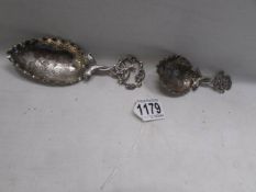 Two ornate silver caddy spoons.