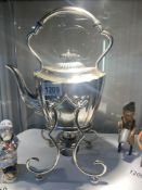 A silverplate kettle on stand