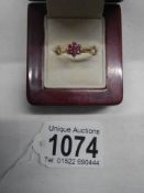 A ruby stone set ring in a cluster design, hall marked London 1965