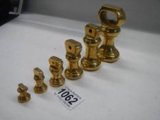 A good set of brass bell weights, half ounce to one pound.