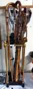 A brass and iron umbrella/stick stand with walking sticks, bamboo carpet beater etc COLLECT ONLY