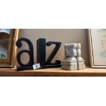 A pair of A to Z bookends and a pair of tribal marble statue bookends