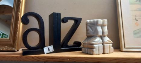 A pair of A to Z bookends and a pair of tribal marble statue bookends