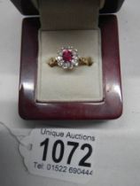 A red and white stone set ring. 9ct.