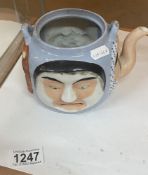 An early Japanese pottery facial teapot, missing lid