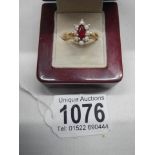 A garnet and pearl set ring in 10ct gold stamped.