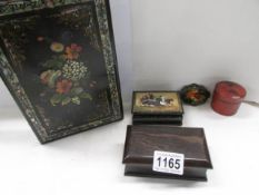 A Russian Lacquered snuff box, three other boxes and a lacquered blotter.