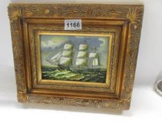 A gilt framed study of a tall ship in sail.