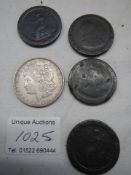 Four 1797 cartwheel pennies and a 1921 USA one dollar coin.