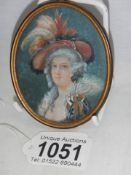 A miniature brass framed painting of a Victorian lady,