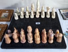 A polished stone African chess set on a chess board (2 pieces a/f, some smaller ones have nibbles)