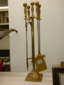 A good quality brass fireside companion set,