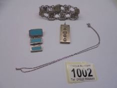 A silver 1 oz ingot, a silver pendant, a silver chain and a silver bracelet.
