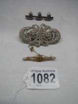 A vintage silver brooch designed as masted sailing ships together with a 9ct gold peridot brooch and