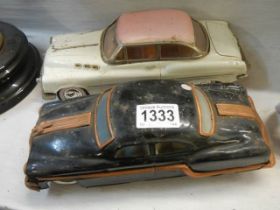 Two old tin plate cars.