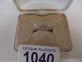 An 18ct gold three stone diamond ring, size K, 2 grams/