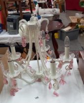 A five arm chandelier ceiling light with pink glass droppers