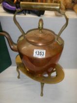 A copper kettle on a brass trivet.