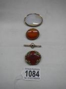 A 19th century stone set brooch, an agate brooch, a 9ct gold brooch set amethyst and another