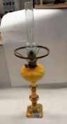 A Victorian peg font oil lamp on brass candlestick