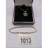 A 9ct gold heart pendant and a 9ct gold bracelet, 10.83 grams.