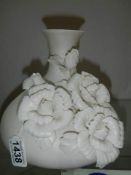 A floral encrusted vase.