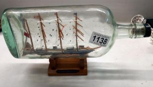 A vintage ship in bottle of a cutter circa 1700