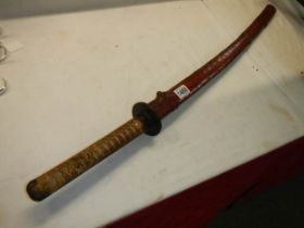 A Japanese Officers Katana sword with shagreen hilt and leather scabbard, no marking on hilt, in