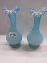 A pair of pale blue glass vases.