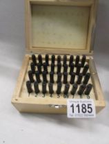 A boxed set of letter and number stamps.