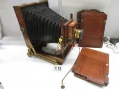 A good late Victorian wood and brass plate camera by Thornton Pickard with spare plates.