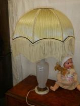 A table lamp with good fringed shade.