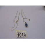 A 9ct gold blue stone pendant and another 9ct gold chain. 4.4 grams.
