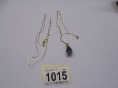 A 9ct gold blue stone pendant and another 9ct gold chain. 4.4 grams.