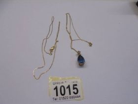 A 9ct gold blue stone pendant and another 9ct gold chain. 4.4 grams.