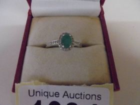 An oval top quality emerald and diamond ring set in yellow gold, size K half, 2.1 grams.