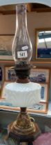 An oil lamp with white glass font