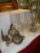 A mixed lot of oil lamp fonts, chimneys etc., COLLECT ONLY.