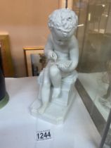 A sitting cherub figure