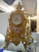 A French brass mantle clock with hand painted Sevres panels, in working order COLLECT ONLY.