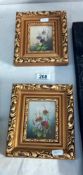 A pair of small gilt framed prints of flowers
