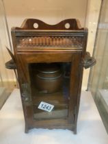 A Victorian/Edwardian oak smokers cabinet with tobacco jar