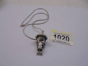 A Japanese articulated figure pendant.