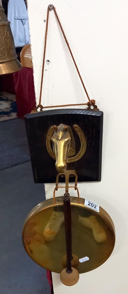 A brass horse head mounted gong