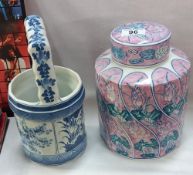A pottery lidded jar and a blue and white china pail/bucket