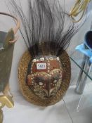 An old tribal mask with wicker surround, a/f.