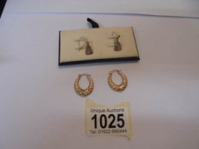 Two pairs of 9ct gold earrings - one pendant style and one hoop.