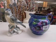 A Staffordshire pottery jug and bird figure.
